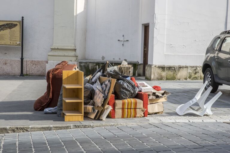 Bulky waste on the street. Broken beds, chairs, garbage furniture on pavement ready for bulky waste collection.