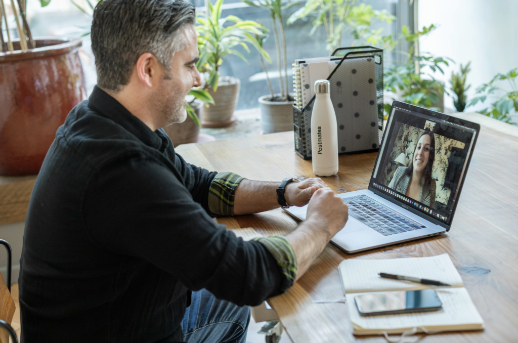 Man sitting at table on a video call. 