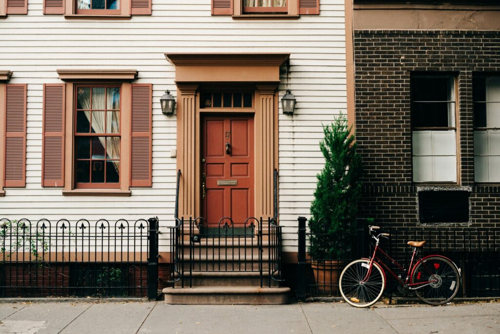 Front door of a home with a bike outside.