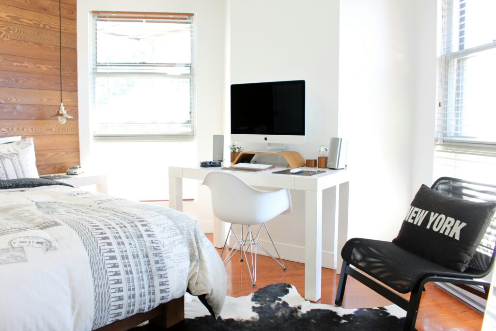 Small bedroom with desk and Apple computer