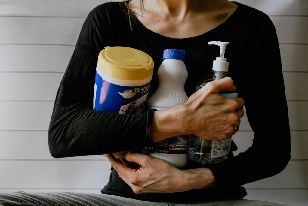 Woman holding cleaning supplies